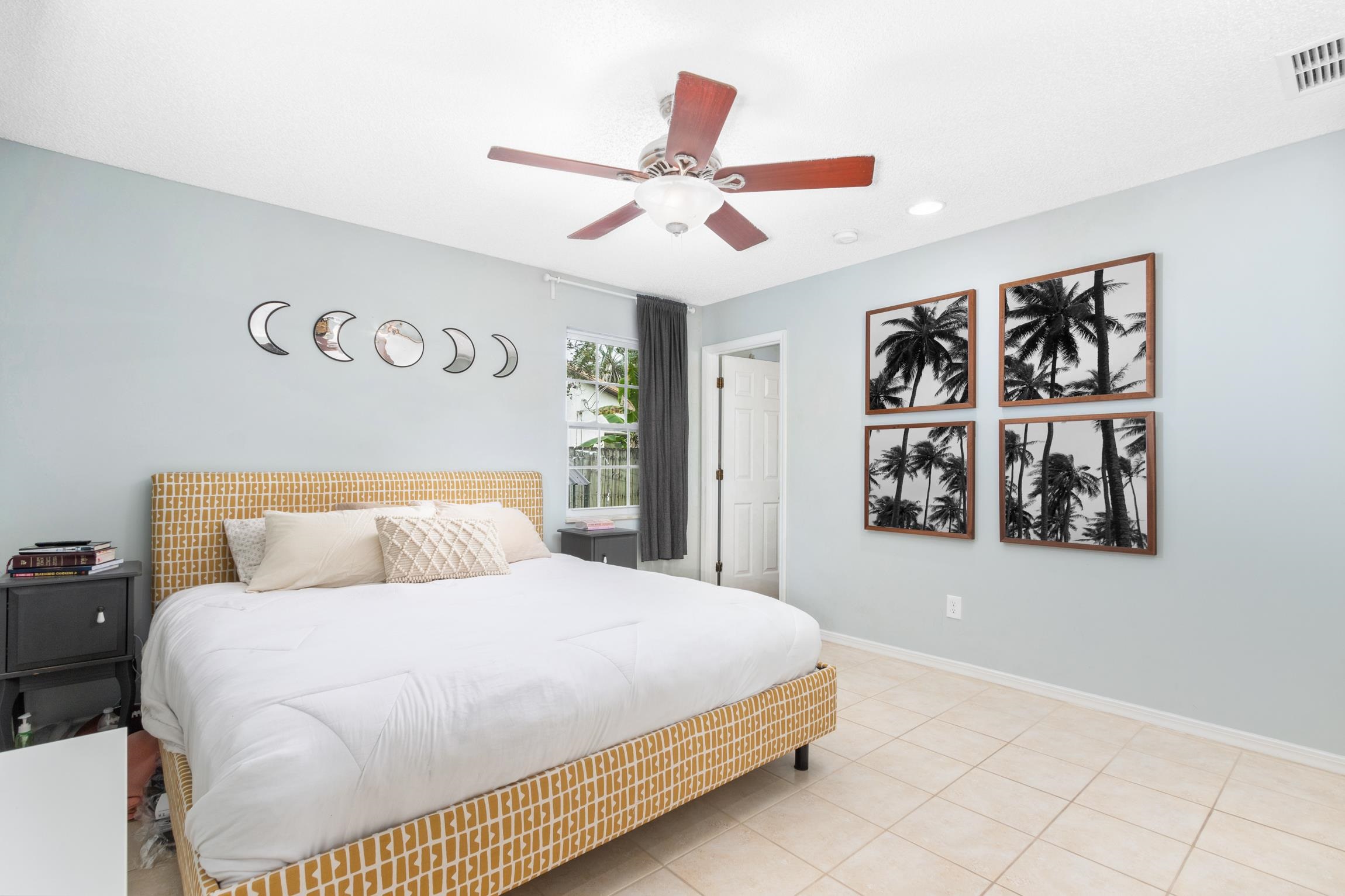 359 Shamrock Road St. Augustine, FL 32086 - Photo 18 of 39 a bedroom with a large bed and a chandelier