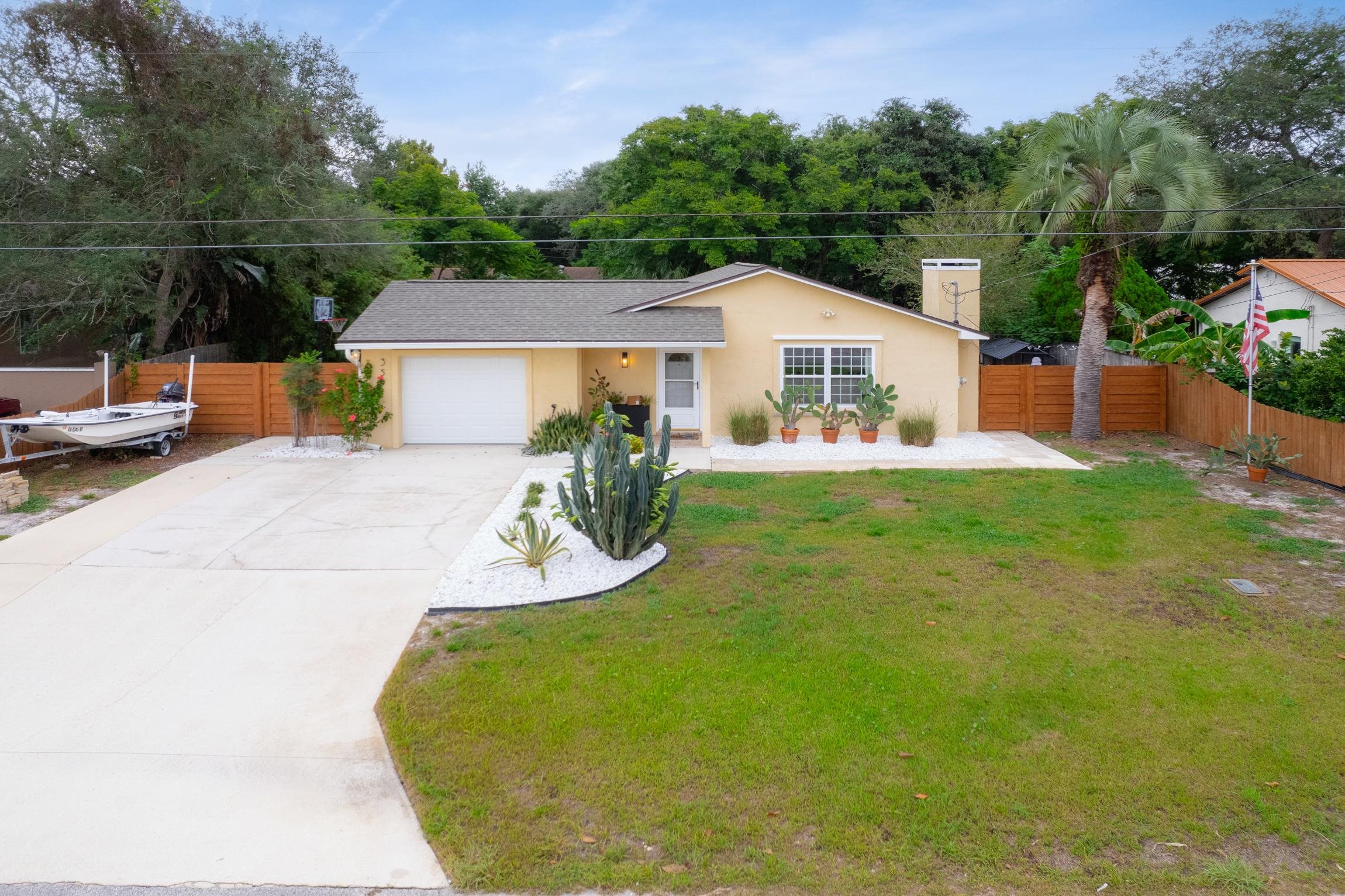 359 Shamrock Road St. Augustine, FL 32086 - Photo 30 of 39 a view of a house with a yard patio and sitting area