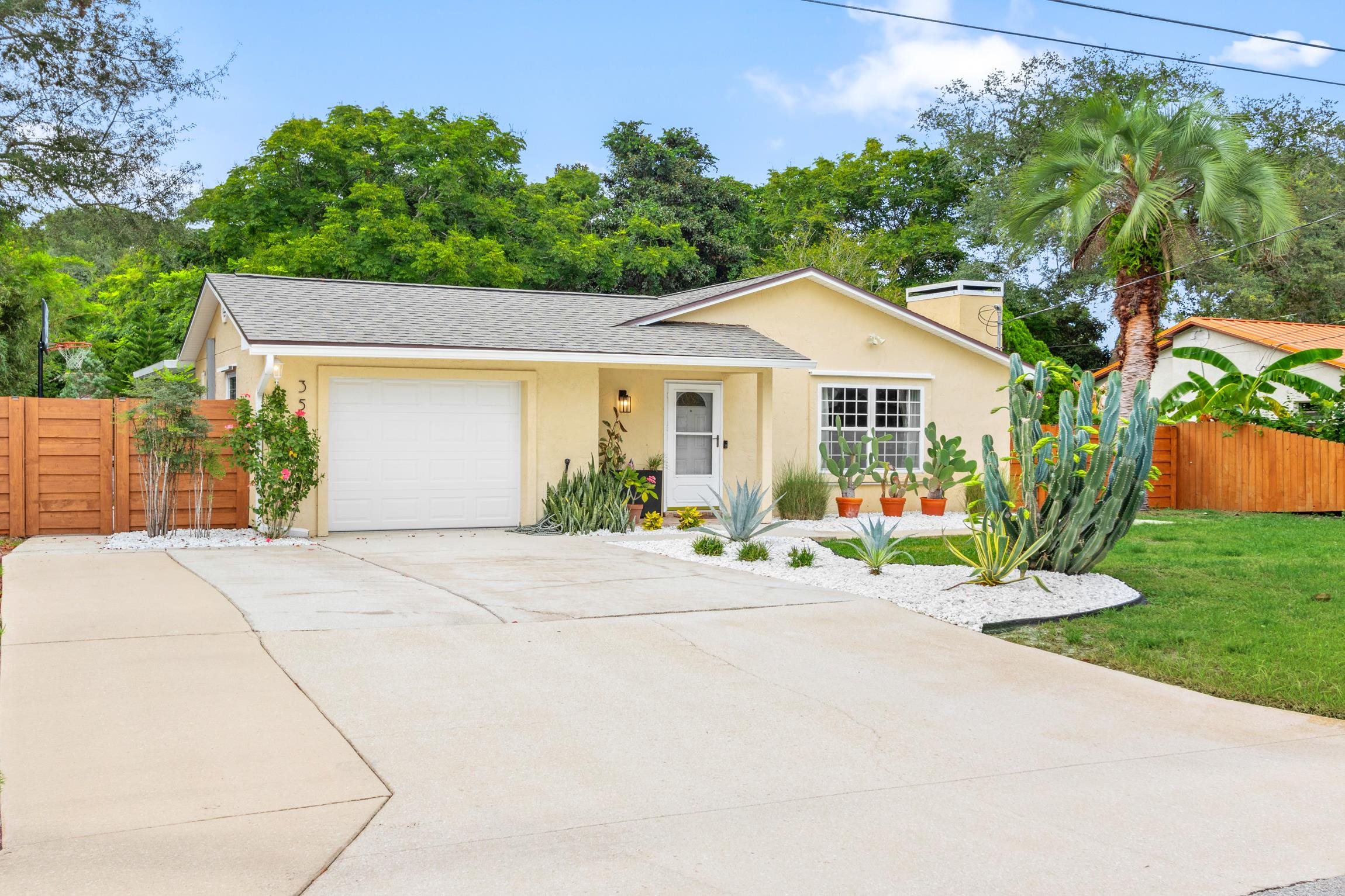 359 Shamrock Road St. Augustine, FL 32086 - Photo 4 of 39 a front view of a house with a yard and potted plants