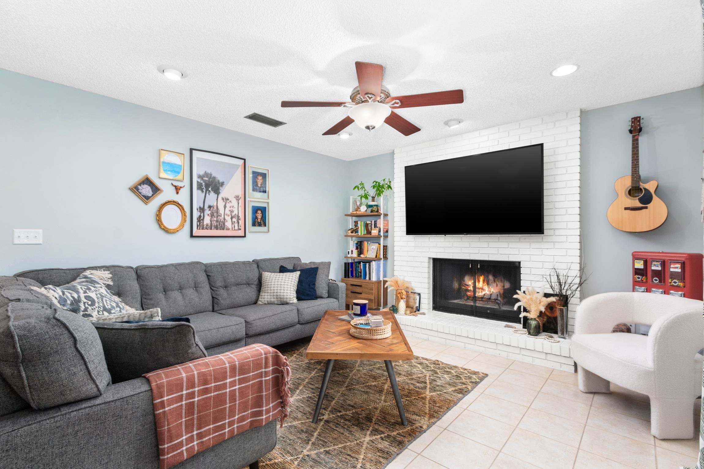 359 Shamrock Road St. Augustine, FL 32086 - Photo 6 of 39 a living room with furniture a flat screen tv and a fireplace