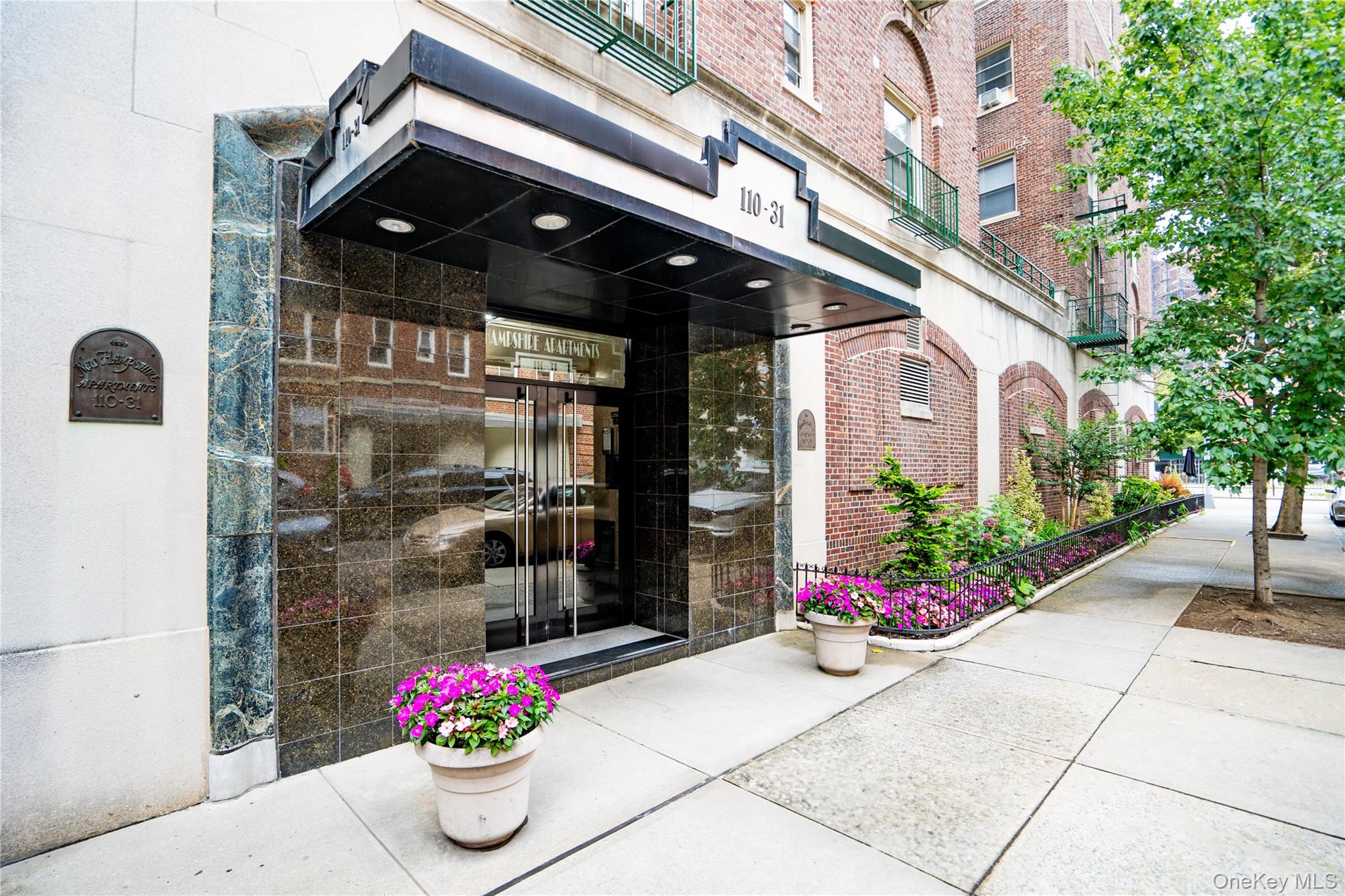 110-31 73rd Road, Unit 4N Queens, NY 11375 - Photo 13 of 15 a front view of a building with flowers