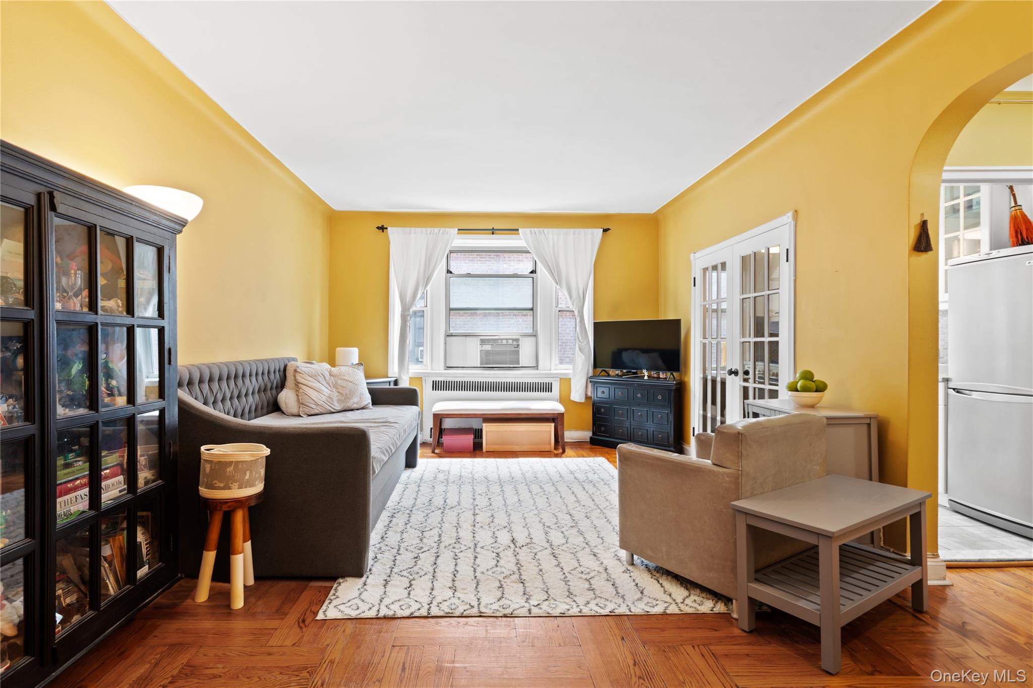 110-31 73rd Road, Unit 4N Queens, NY 11375 - Photo 2 of 15 a living room with furniture fireplace and a large window