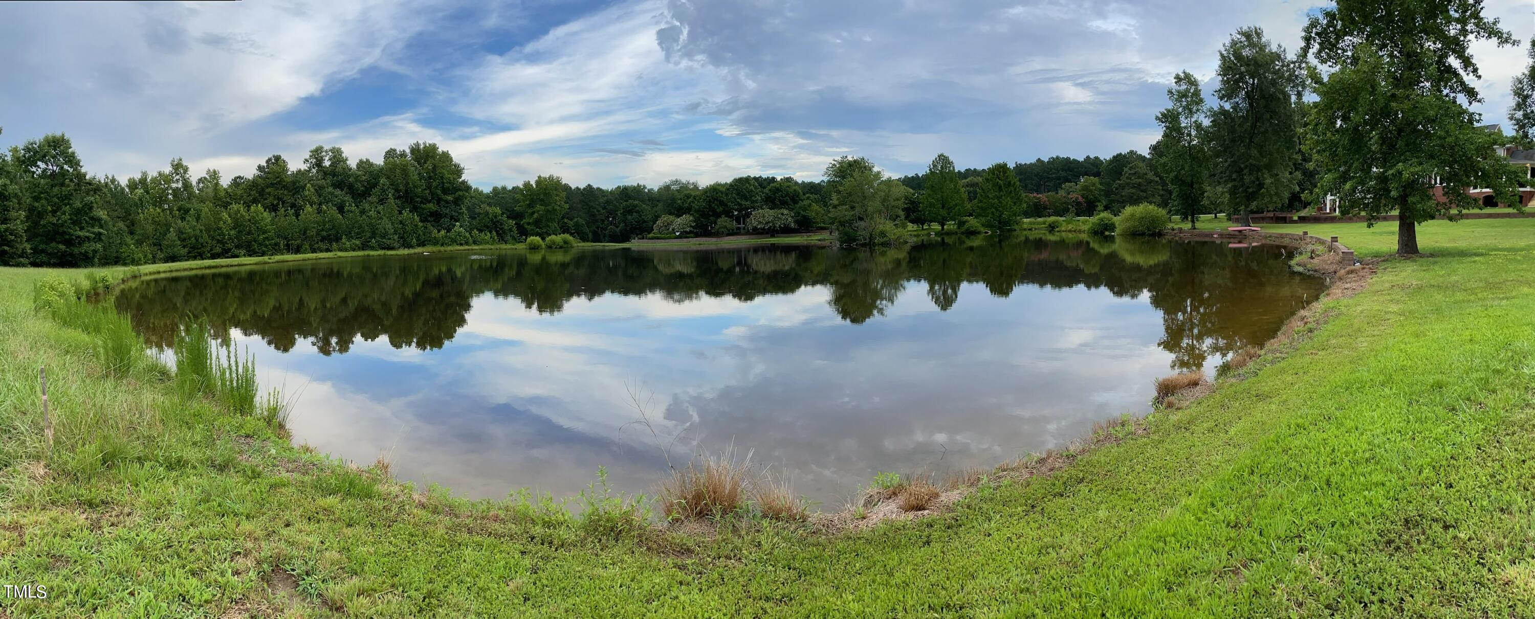 Lot 3 Wiggins Road Louisburg, NC 27549 - Photo 6 of 8 a view of a lake with a yard and large trees