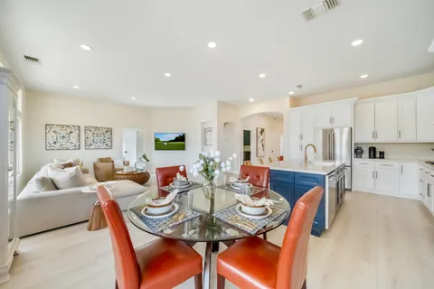 a living room with furniture kitchen and a table