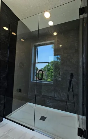 a bathroom with double vanity white cabinets and two mirror