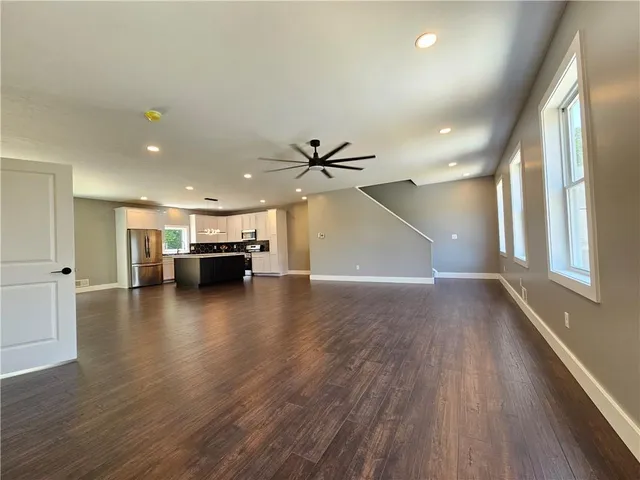 a view of kitchen and hall with wooden floor