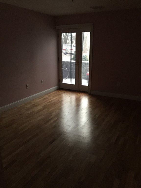 25 Alpine Street, Unit 1 Boston, MA 02136 - Photo 6 of 9 a view of wooden floor and windows in a room