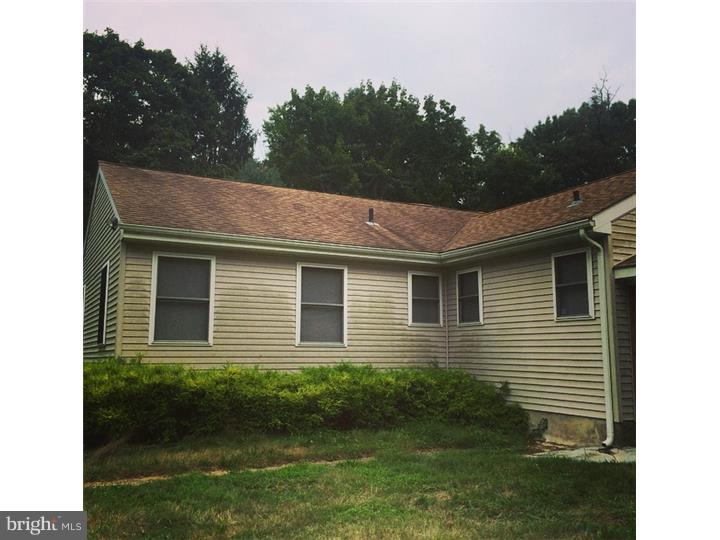 241 Weymouth Road Buena, NJ 08310 - Photo 19 of 21 a brick house with a yard plants and large tree