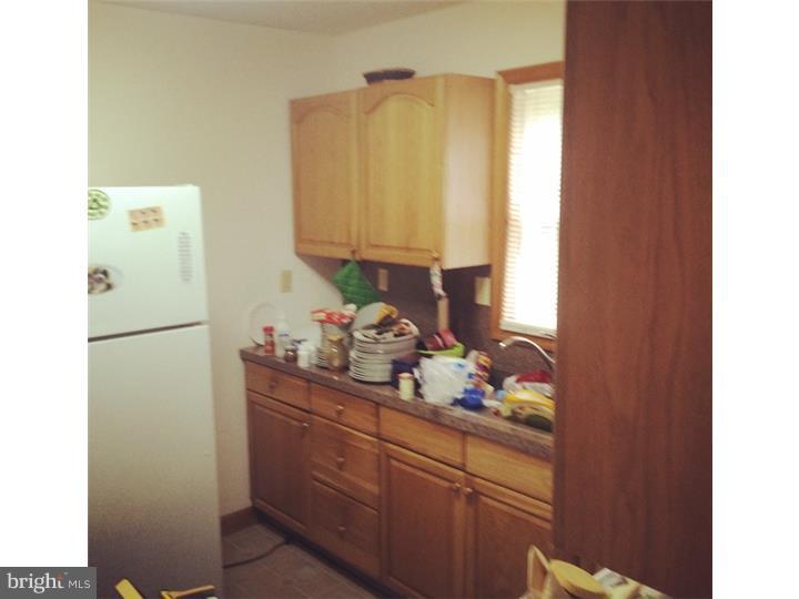 241 Weymouth Road Buena, NJ 08310 - Photo 3 of 21 a kitchen with a refrigerator and a sink
