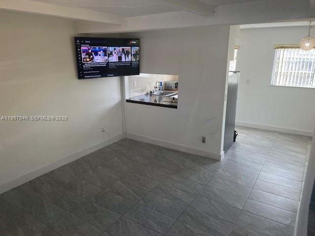 1220 Southwest 5th Street, Unit 21 Miami, FL 33135 - Photo 7 of 14 a room with storage and a flat screen tv