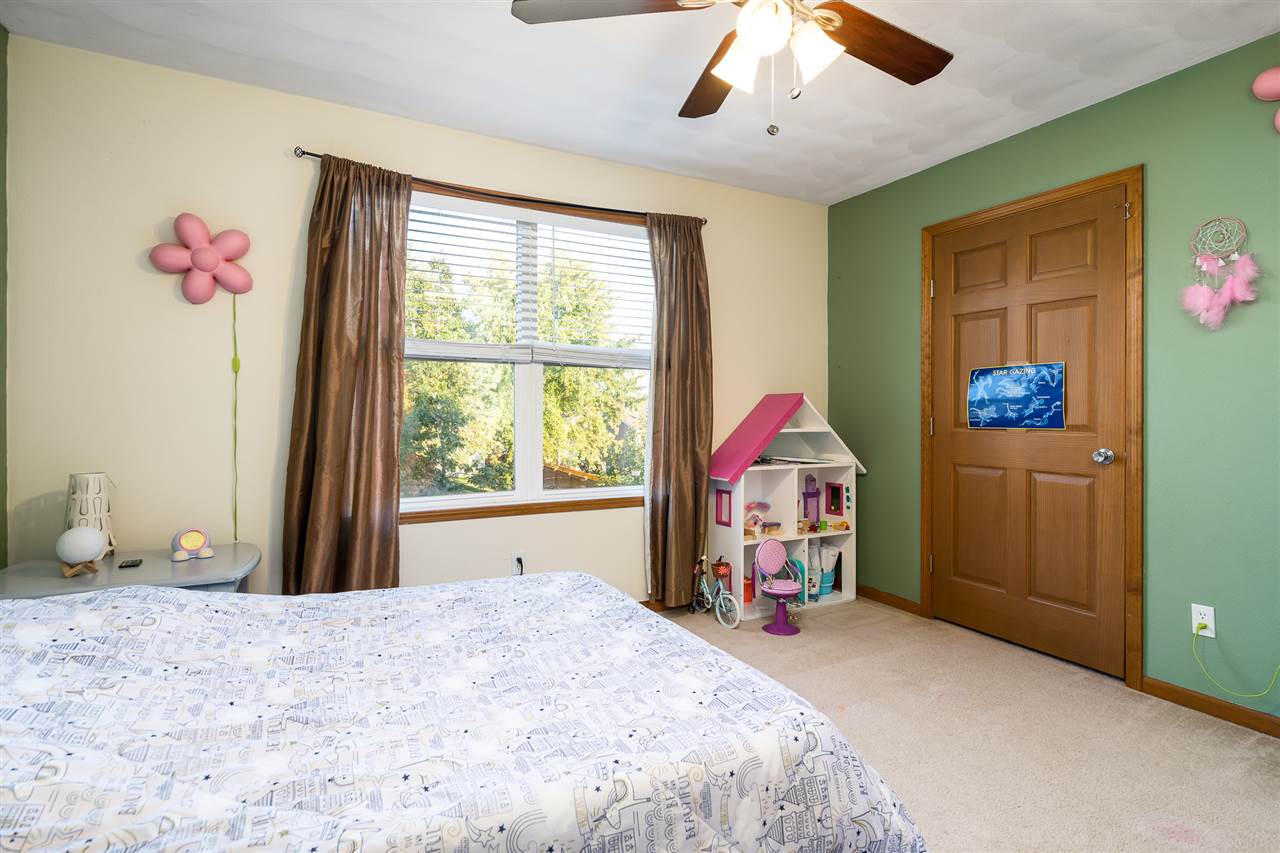 15639 Stonecrest Road South Beloit, IL 61080 - Photo 24 of 37 a bedroom with a bed and a chandelier