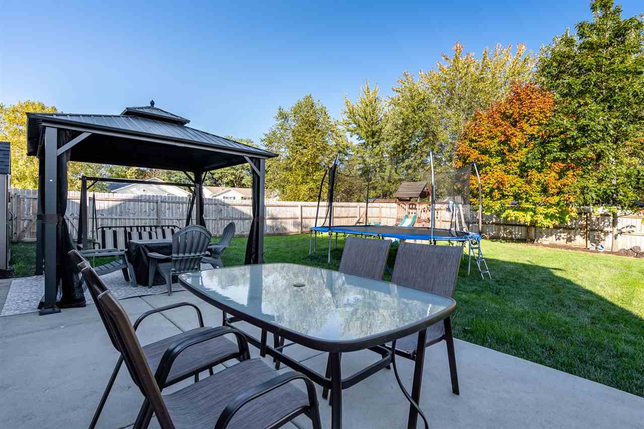 15639 Stonecrest Road South Beloit, IL 61080 - Photo 35 of 37 a view of a patio with a table chairs and a backyard