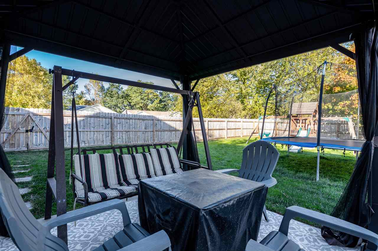 15639 Stonecrest Road South Beloit, IL 61080 - Photo 36 of 37 a view of a patio with a table chairs and a backyard