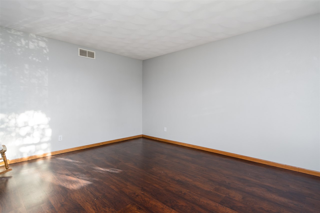 15639 Stonecrest Road South Beloit, IL 61080 - Photo 5 of 37 a view of an empty room with wooden floor and a window