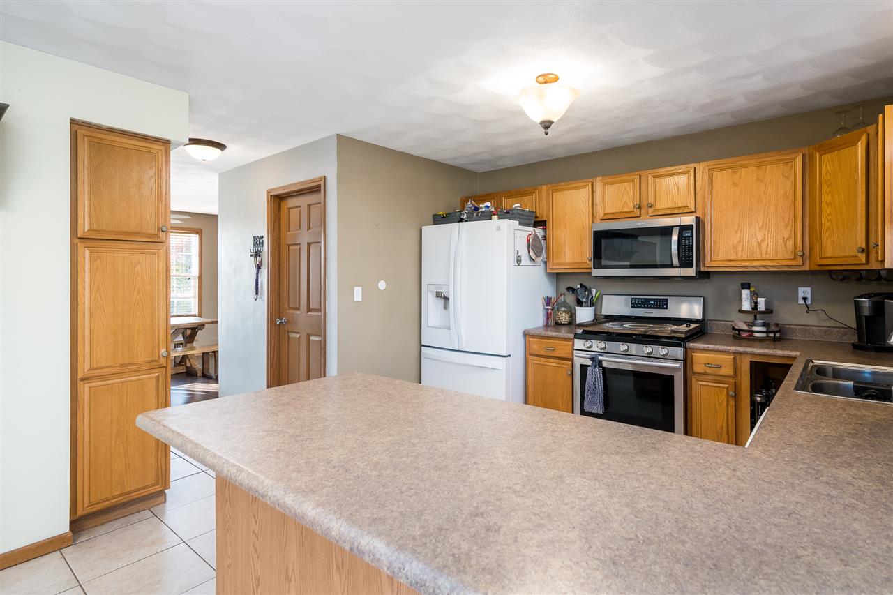 15639 Stonecrest Road South Beloit, IL 61080 - Photo 10 of 37 a kitchen with stainless steel appliances granite countertop a refrigerator stove top oven a sink and dishwasher