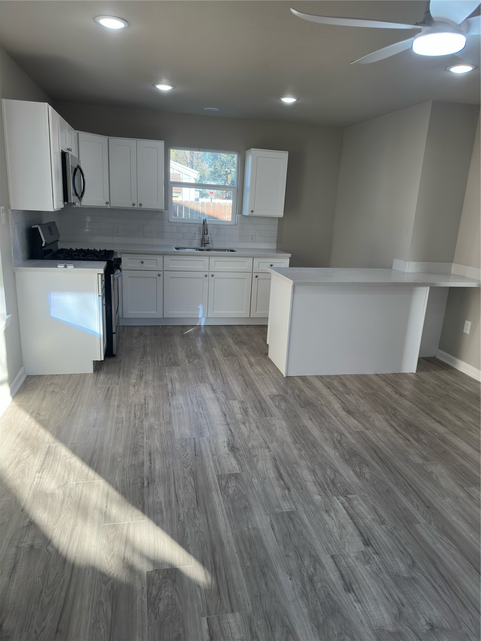 9935 Algiers Road, Unit B Houston, TX 77041 - Photo 2 of 6 a kitchen with granite countertop a stove a sink and a refrigerator