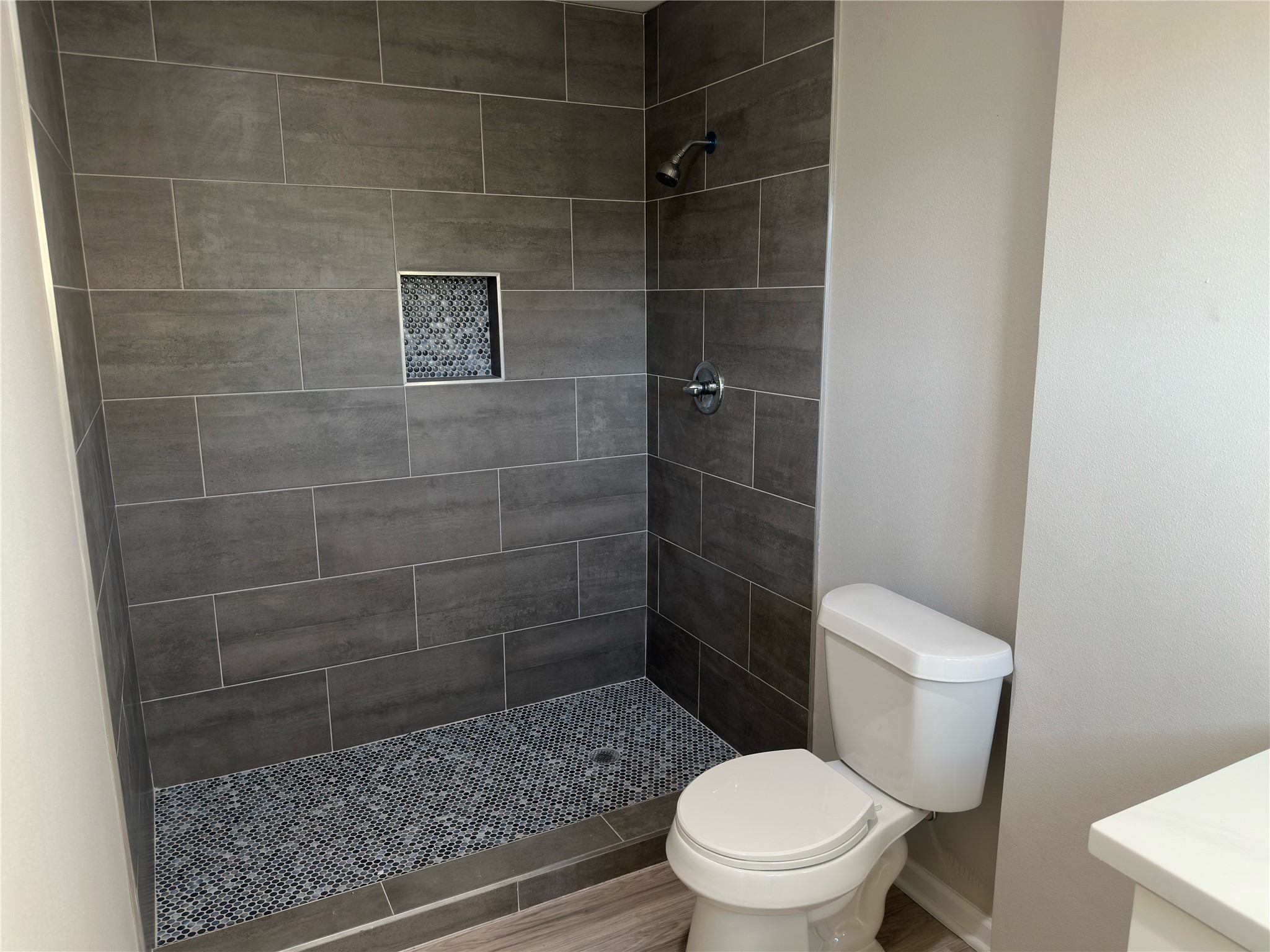 9935 Algiers Road, Unit B Houston, TX 77041 - Photo 4 of 6 a white toilet sitting next to a bathroom sink