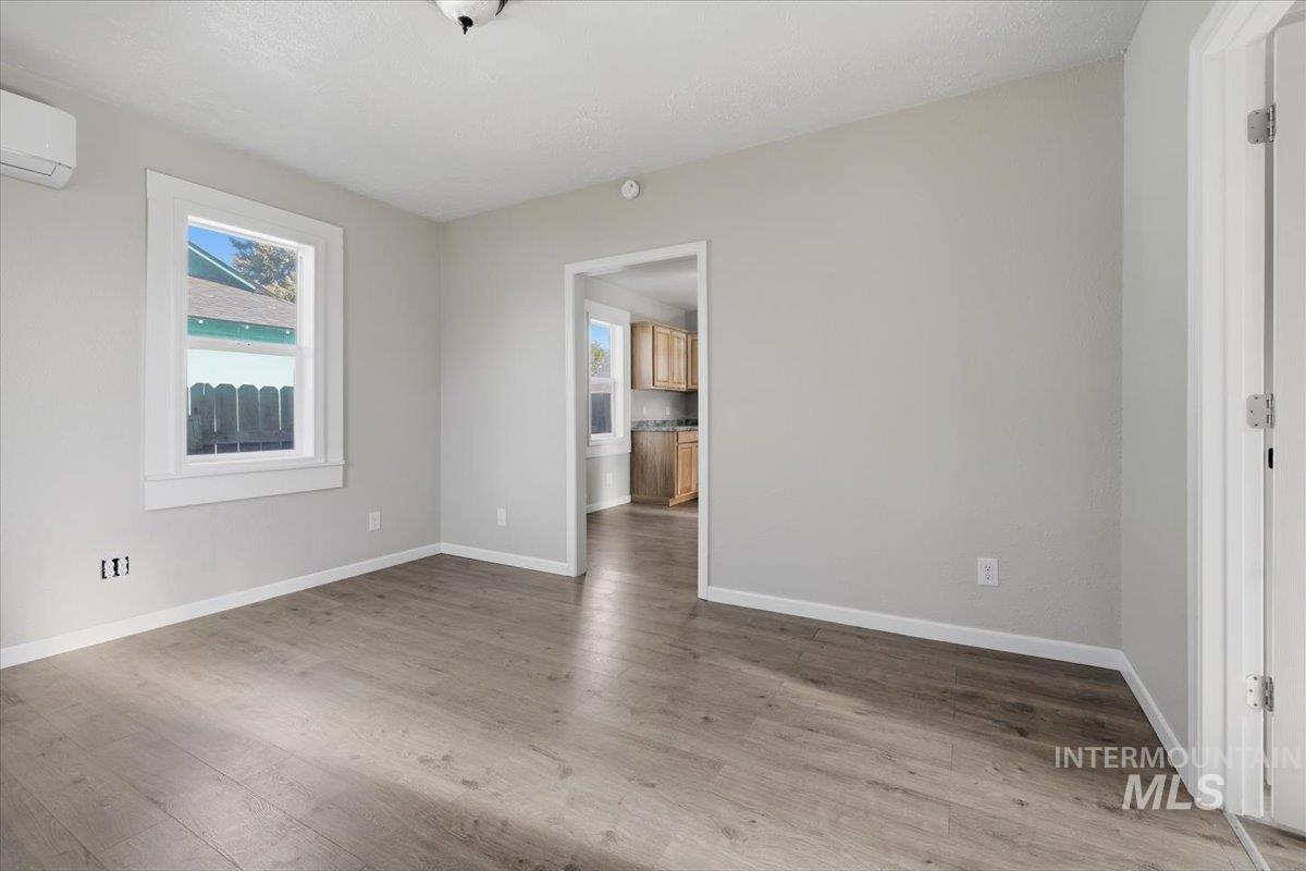284 Fargo Avenue Notus, ID 83656 - Photo 16 of 24 Spacious room featuring wood-finish flooring, light grey walls, and white trim
