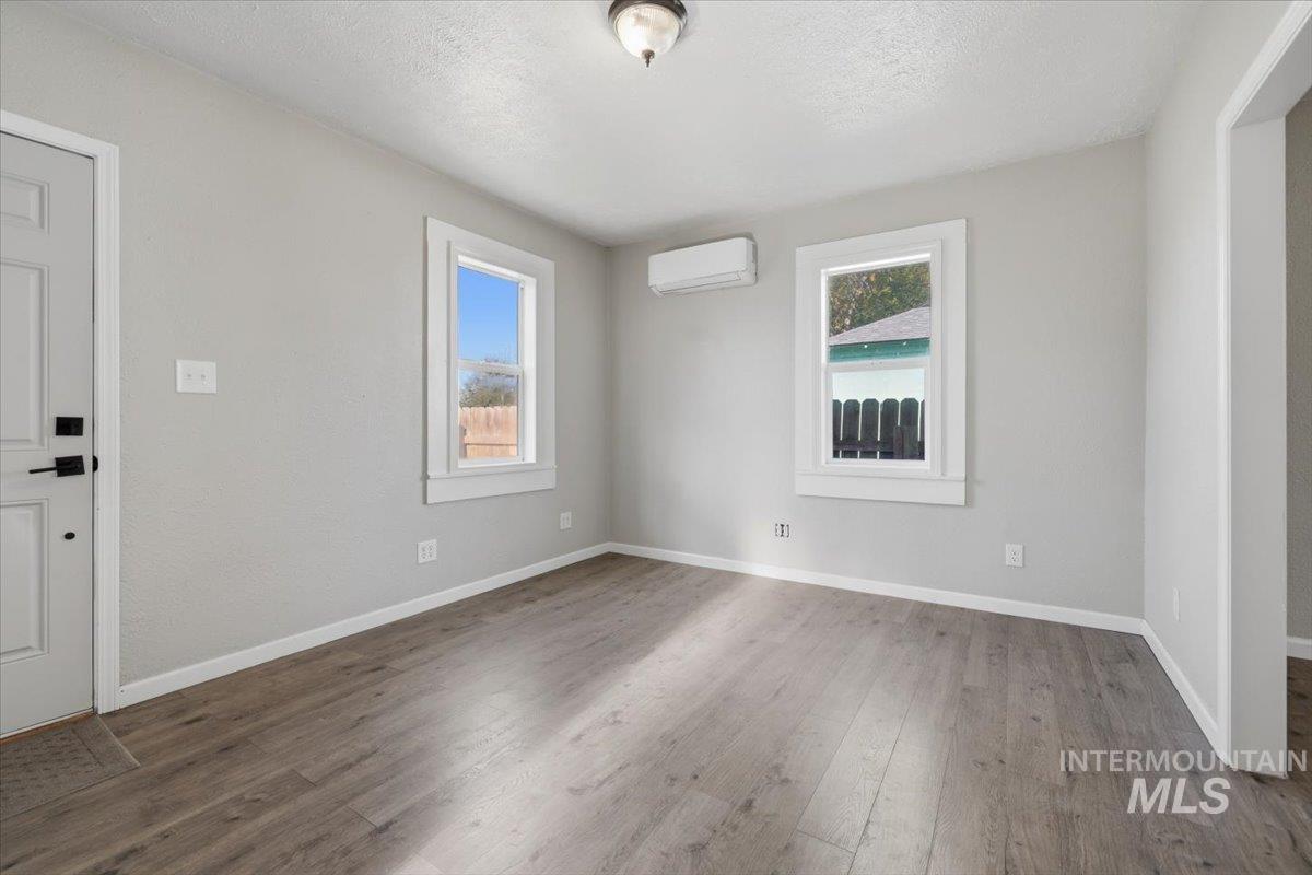 284 Fargo Avenue Notus, ID 83656 - Photo 17 of 24 Spacious room featuring wood-finish flooring, light gray wall tones, and white trim
