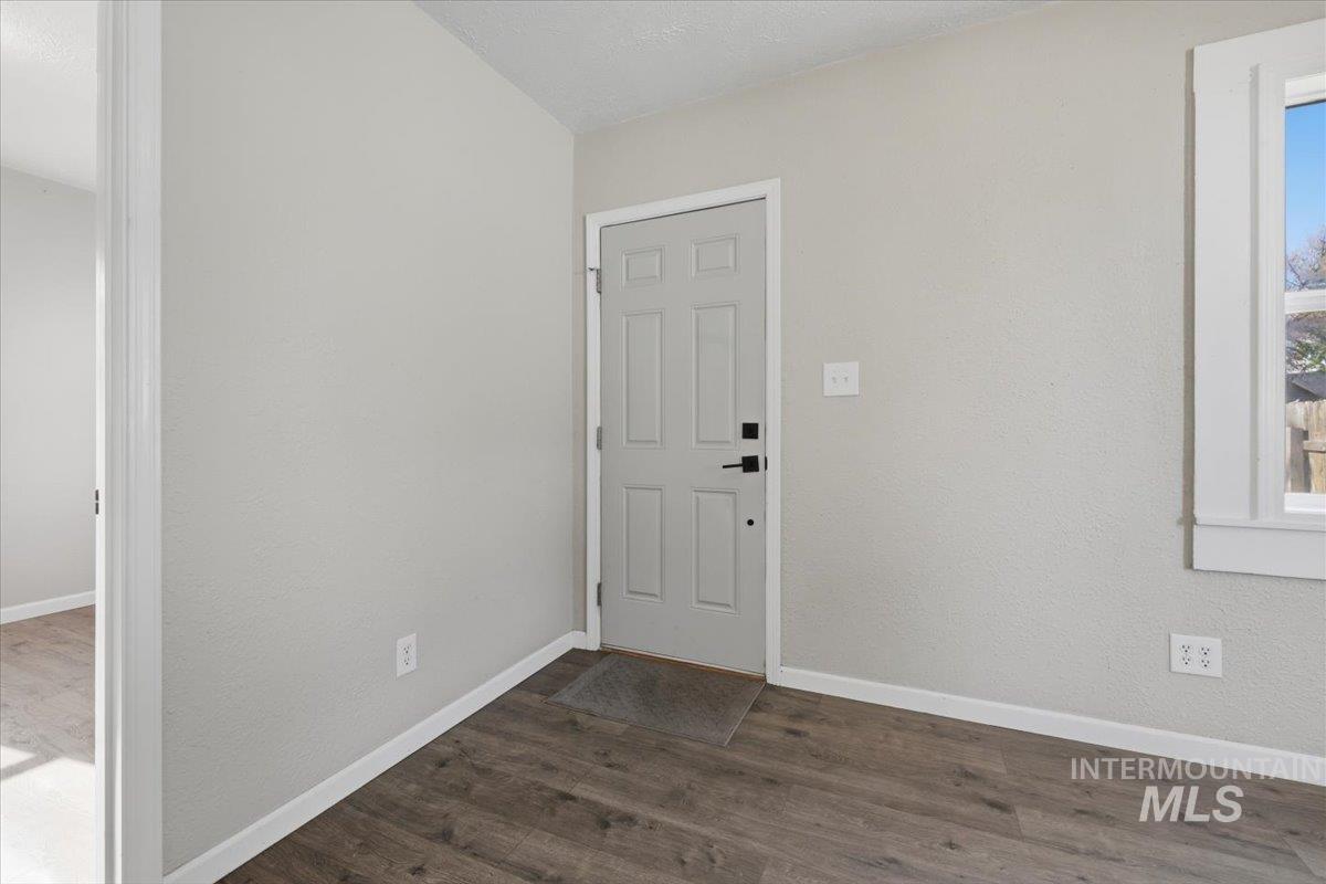 284 Fargo Avenue Notus, ID 83656 - Photo 2 of 24 Entryway with wood-finish flooring, white baseboards, and a paneled entry door with black hardware