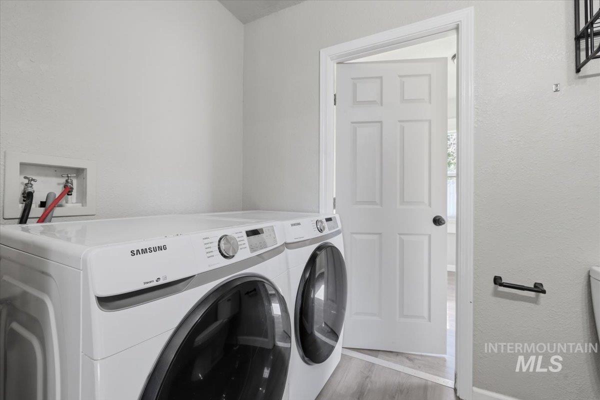 284 Fargo Avenue Notus, ID 83656 - Photo 21 of 24 Dedicated laundry area featuring a washer and dryer hookup, light gray walls, and wood-finish flooring