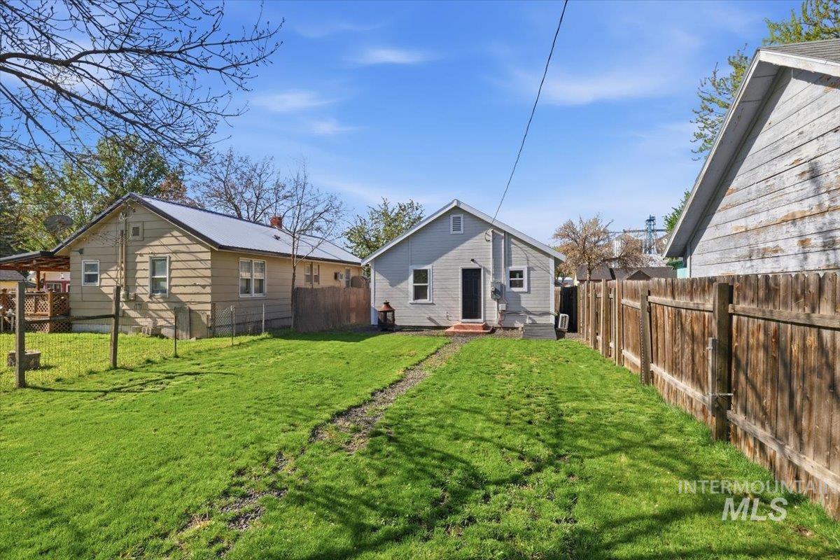 284 Fargo Avenue Notus, ID 83656 - Photo 23 of 24 Expansive green lawn with a wooden privacy fence bordering the property