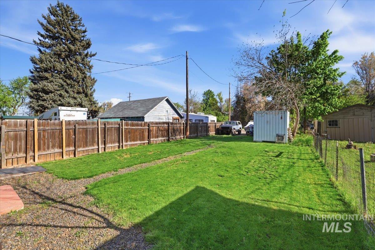 284 Fargo Avenue Notus, ID 83656 - Photo 24 of 24 Expansive outdoor space featuring a manicured lawn, a wooden privacy fence, and a wire fence