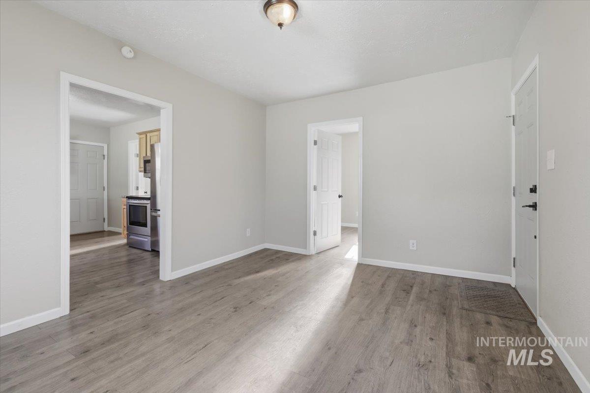 284 Fargo Avenue Notus, ID 83656 - Photo 4 of 24 Spacious interior featuring wood-finish flooring, light grey wall paint, and white trim