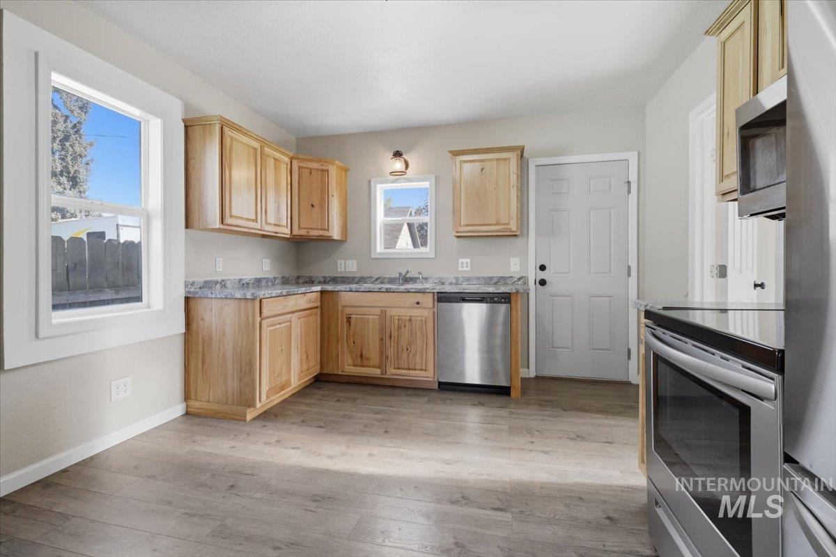 284 Fargo Avenue Notus, ID 83656 - Photo 6 of 24 Kitchen featuring wood-finish cabinetry, speckled countertops, and stainless steel appliances