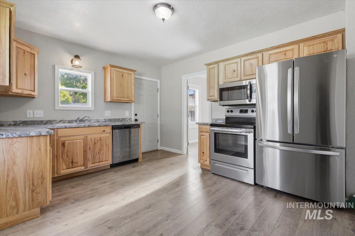 284 Fargo Avenue Notus, ID 83656 - Photo 7 of 24 Kitchen featuring wood cabinetry, light-toned countertops, and stainless steel appliances