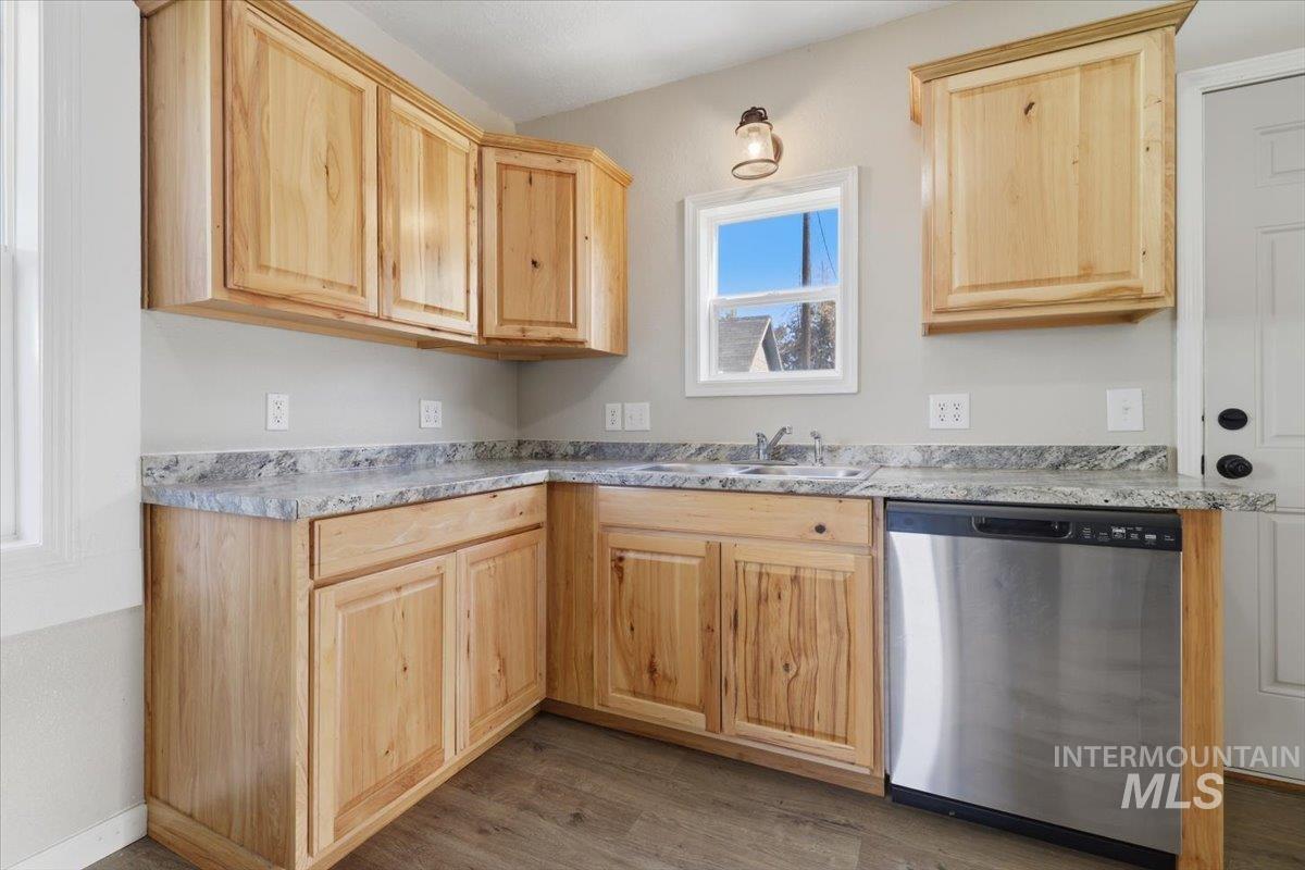 284 Fargo Avenue Notus, ID 83656 - Photo 9 of 24 Kitchen featuring natural wood cabinetry, light gray countertops, stainless steel dishwasher, wood-finish flooring, and a single-basin sink