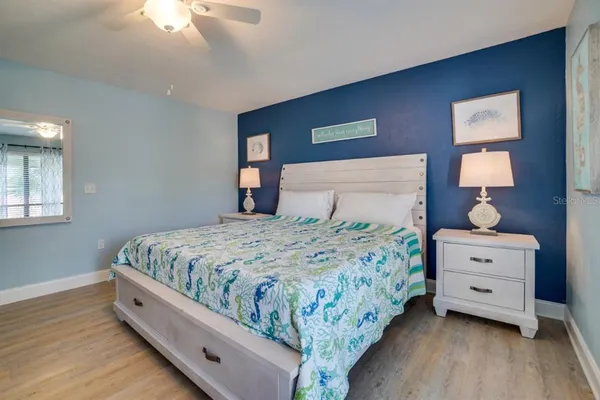 a large bedroom with a bed and a dresser