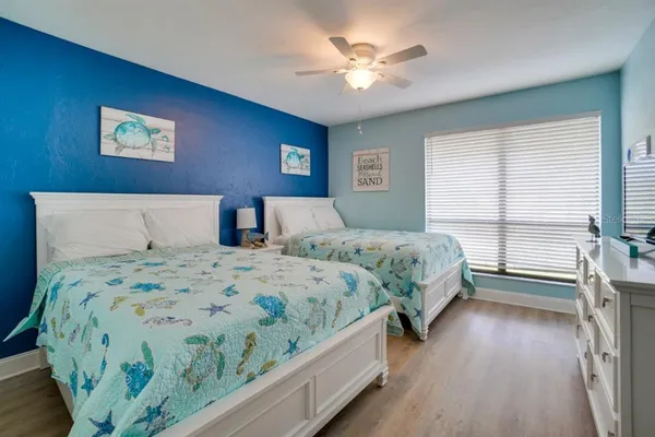 a bedroom with a large bed and a chandelier