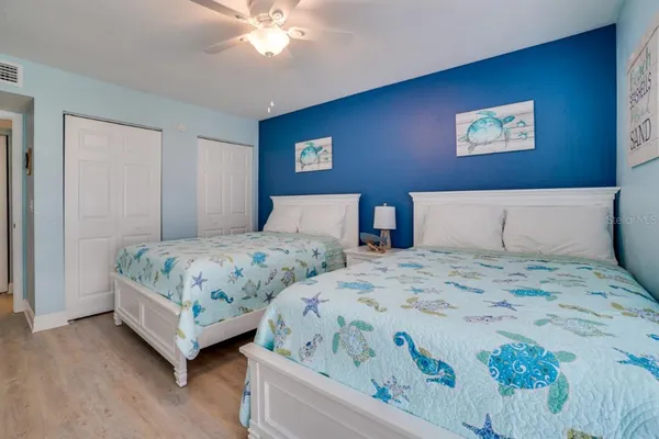 a bedroom with a bed and a wall painting