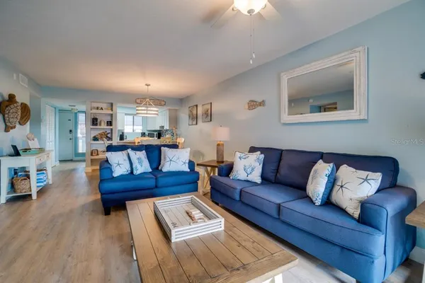 a living room with furniture and a wooden floor
