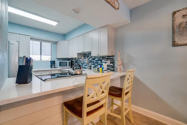 a kitchen with stainless steel appliances a stove a sink and a refrigerator