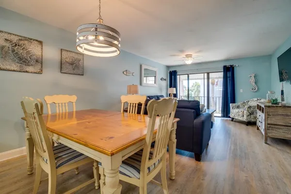 a view of a dining room with furniture and wooden floor