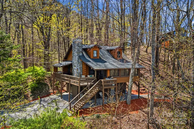 a roof deck with table and chairs under an umbrella