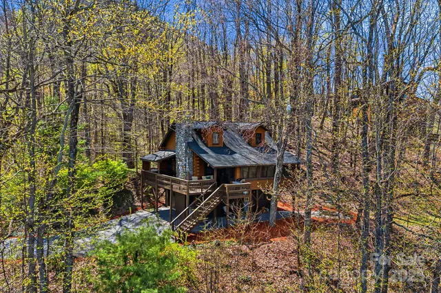 a view of a houses with a lush green hillside