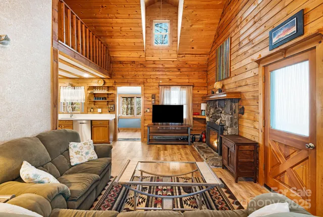 a living room with furniture a fireplace and flat screen tv
