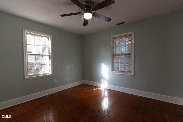 2525 Freeman Street Fayetteville, NC 28301 - Photo 13 of 24 a view of an empty room with wooden floor and a window