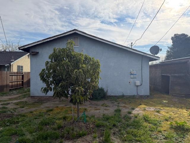1340 Bennett Avenue Dos Palos, CA 93620 - Photo 15 of 16 a backyard of a house with plants and a yard