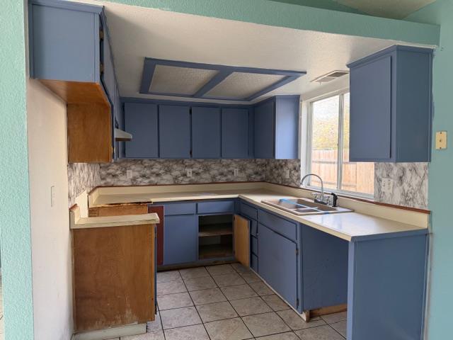 1340 Bennett Avenue Dos Palos, CA 93620 - Photo 7 of 16 a kitchen with a sink stove and cabinets