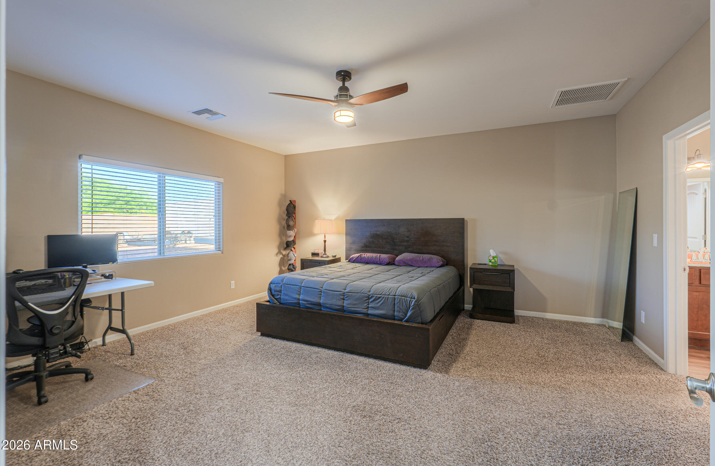 1487 South Mountain View Road Apache Junction, AZ 85119 - Photo 3 of 60 a bedroom with a bed and a window