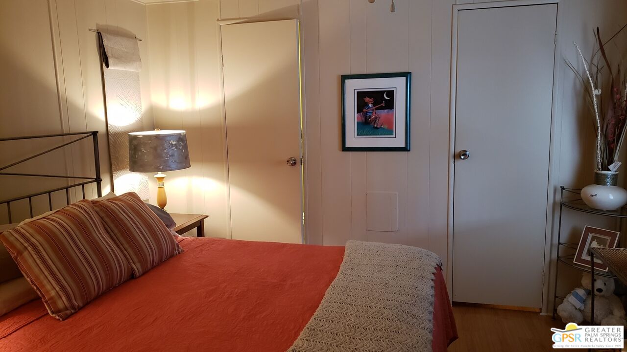 374 Buffalo Road Cathedral City, CA 92234 - Photo 11 of 33 a bedroom with a bed and a lamp