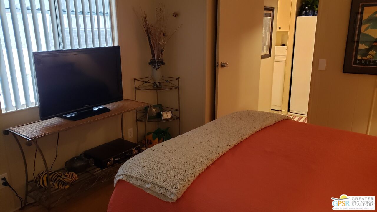 374 Buffalo Road Cathedral City, CA 92234 - Photo 12 of 33 a bedroom with a bed tv and a window