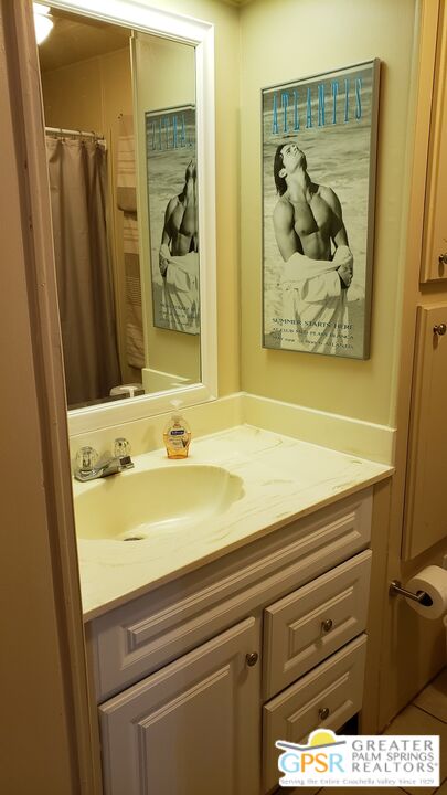 374 Buffalo Road Cathedral City, CA 92234 - Photo 13 of 33 a bathroom with a sink and a mirror