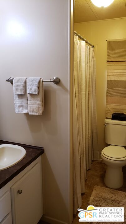 374 Buffalo Road Cathedral City, CA 92234 - Photo 20 of 33 a bathroom with a toilet and a sink