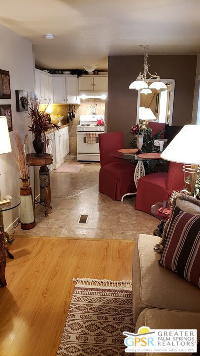 374 Buffalo Road Cathedral City, CA 92234 - Photo 8 of 33 a living room with furniture and a chandelier