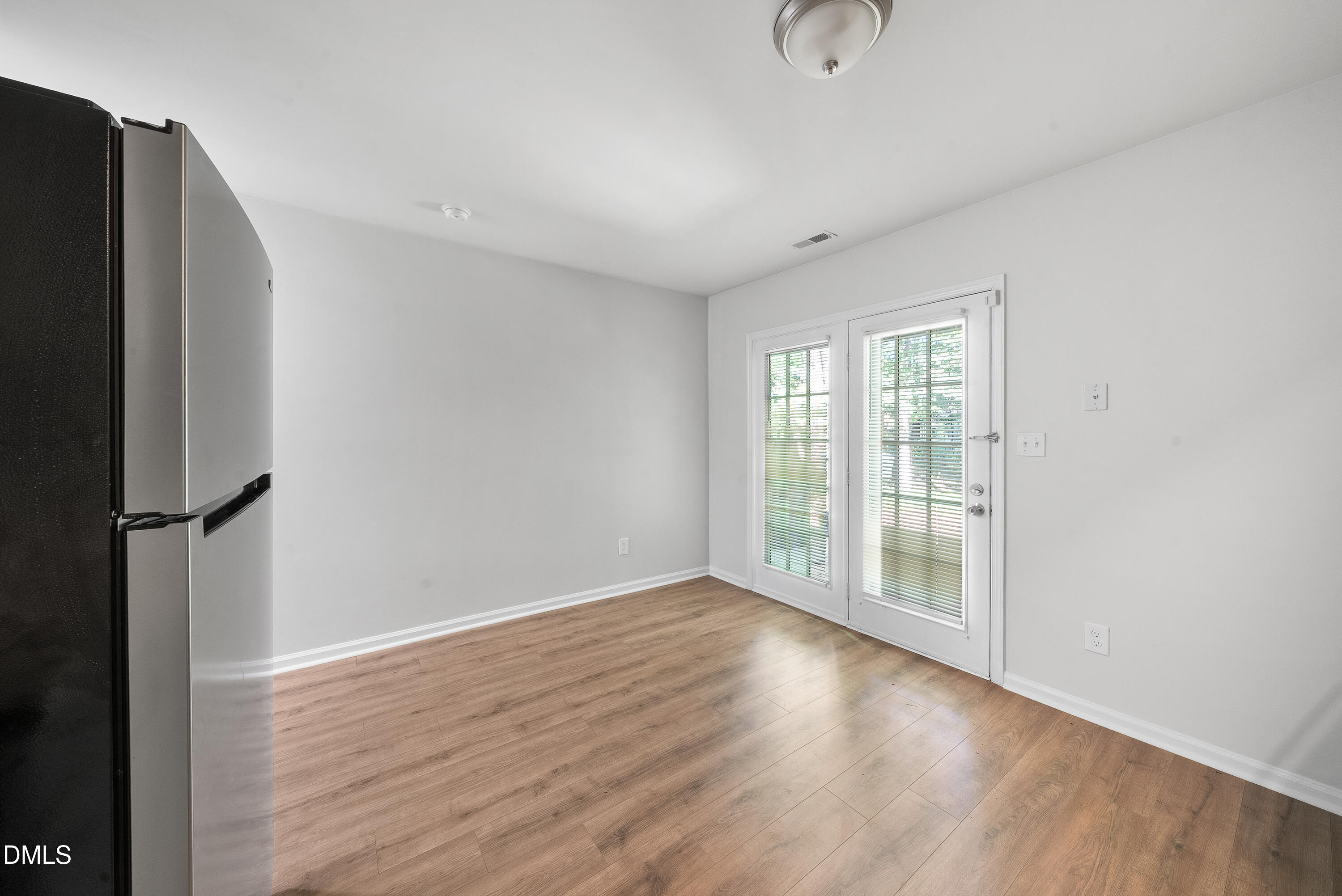 7927 Brown Bark Place Raleigh, NC 27615 - Photo 11 of 25 a view of an empty room with wooden floor and a window